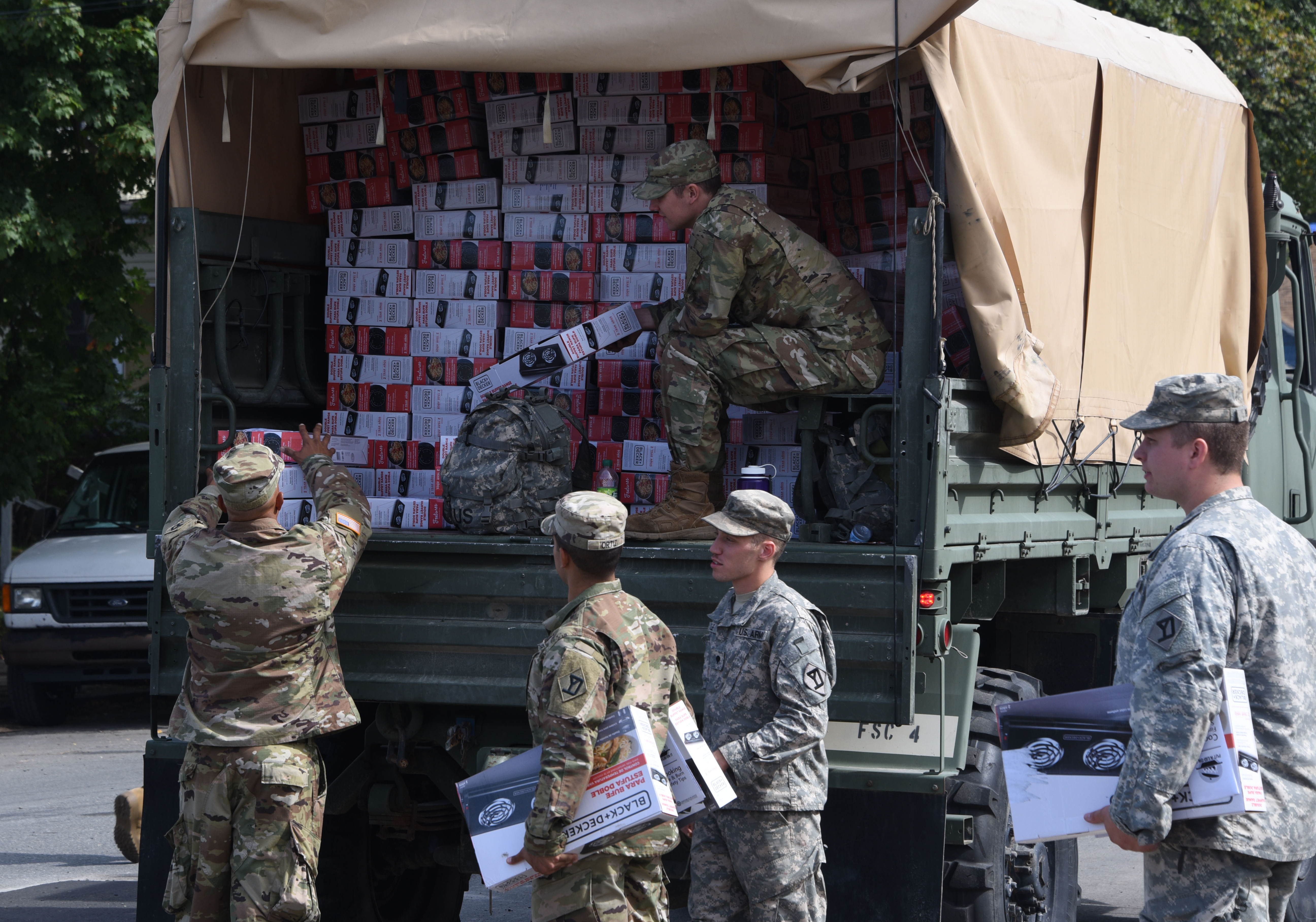 Soldiers of the 101 FSC, 101st  Engineering Battalion, hand out boxes of hot plates in Lawrence, Massachusetts on Sept. 23, 2018. National Guard soldiers and airmen delivered hundreds of hotplates to families throughout Lawrence after the gas explosions in the Merrimack Valley.